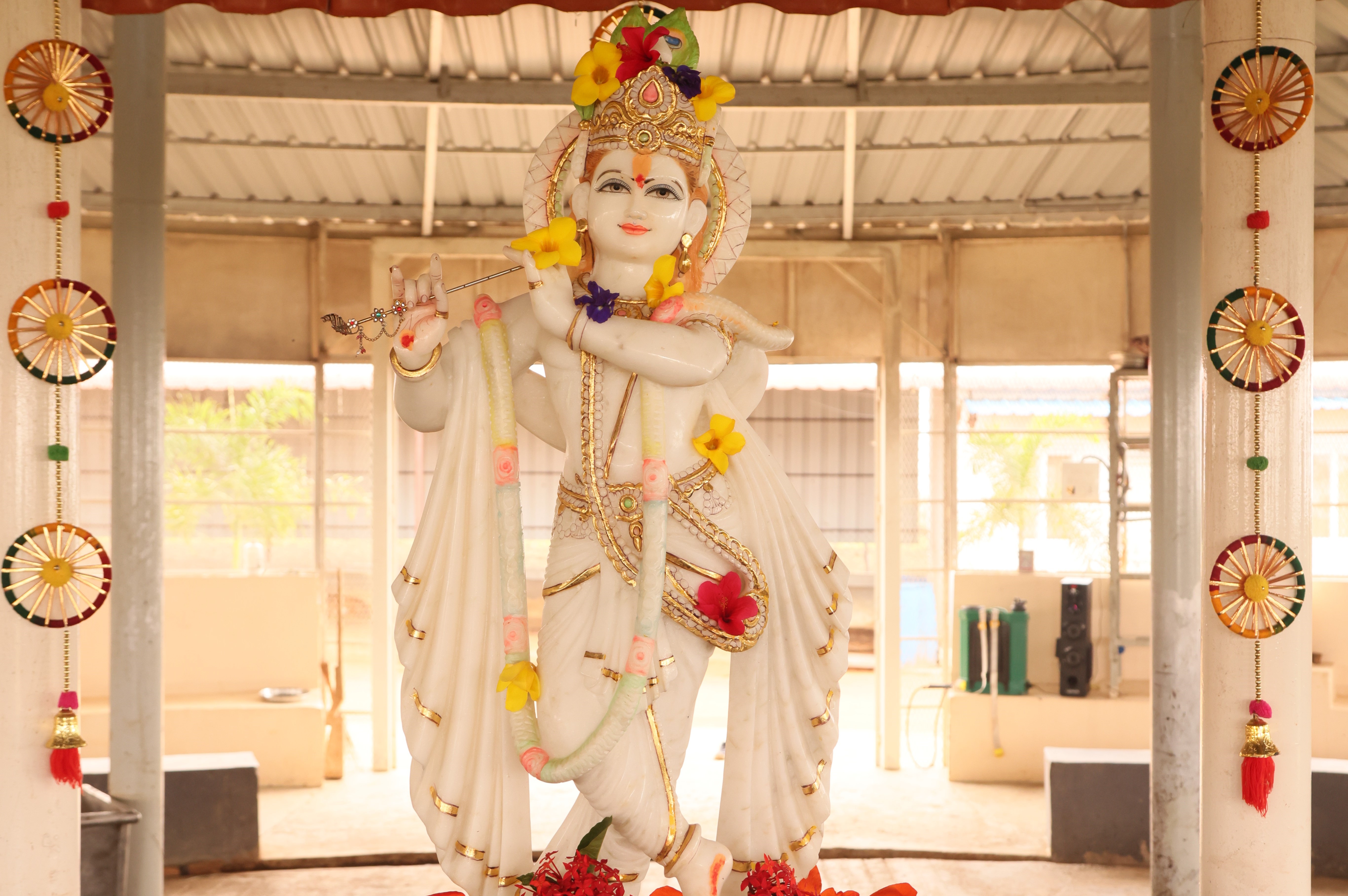 A beautiful white marble statue of Lord Krishna at the property.